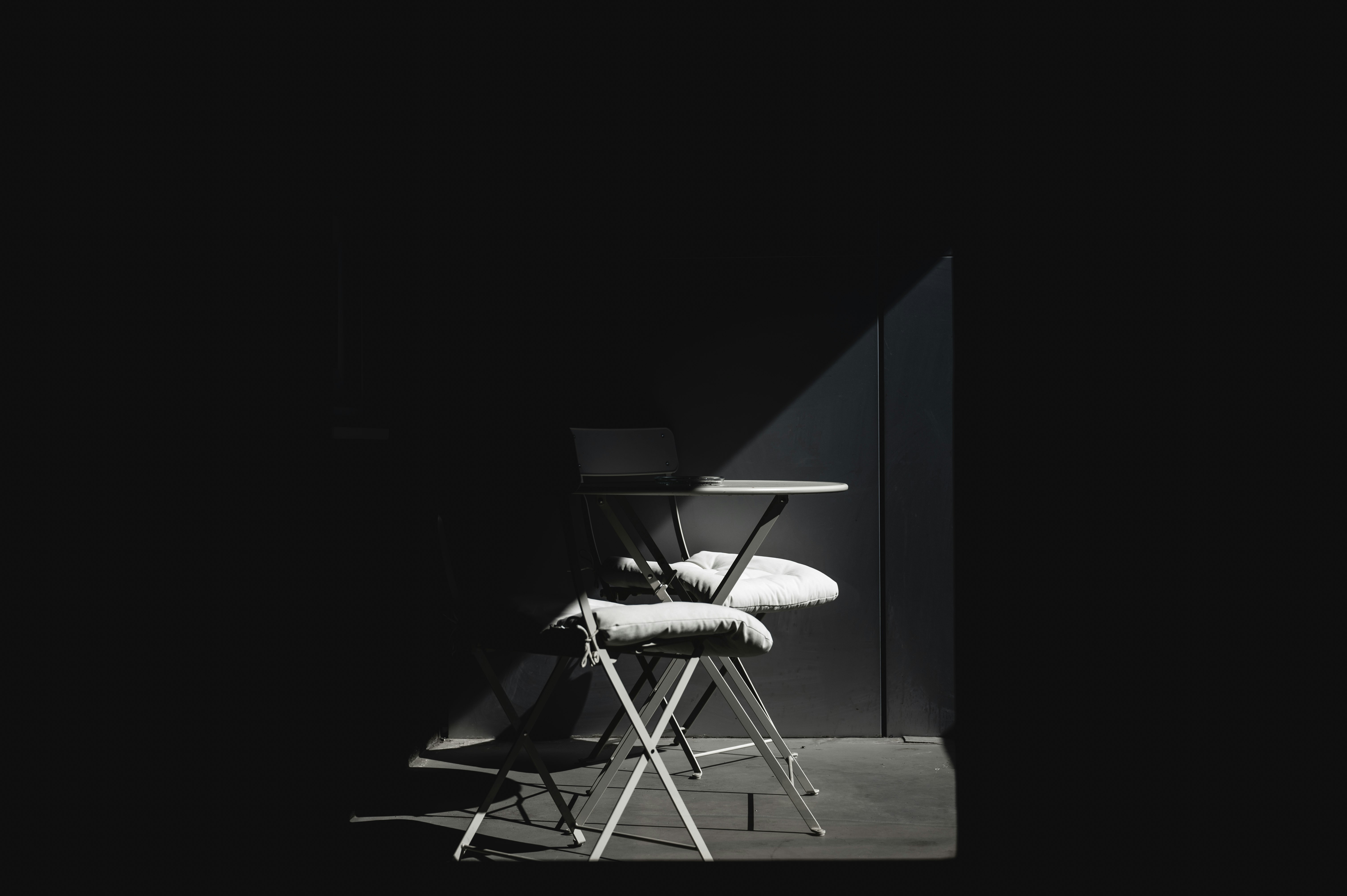 white and black chair on brown wooden table